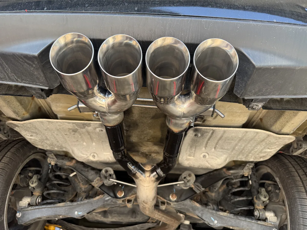Custom quad tip exhaust system installed under a vehicle