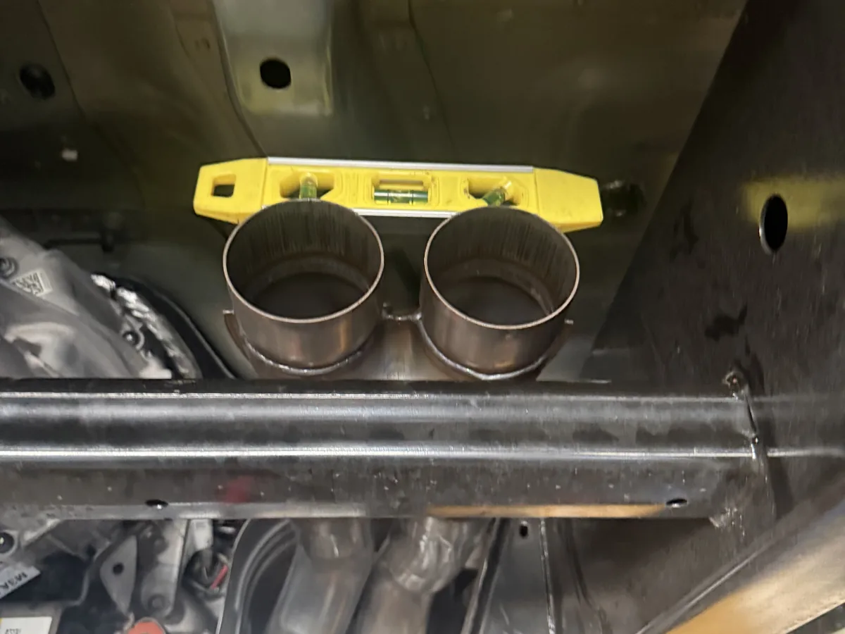 Dual exhaust tips clamped in position during fitting