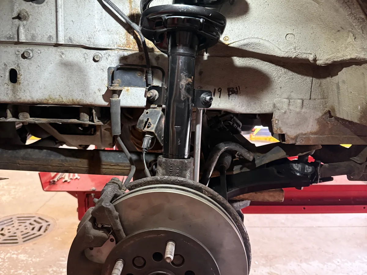 Rebuilt front strut and hub assembly after suspension service on the lift