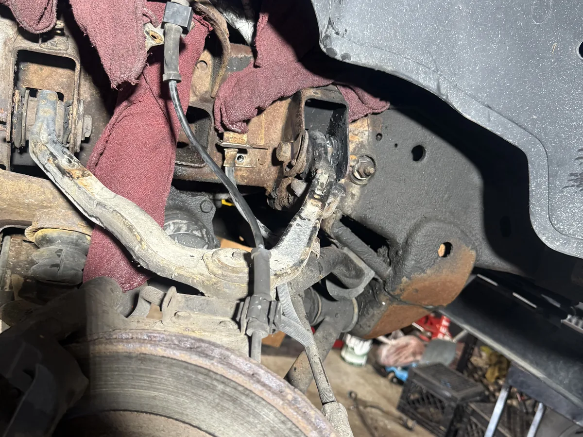 Worn front suspension and steering components before repair