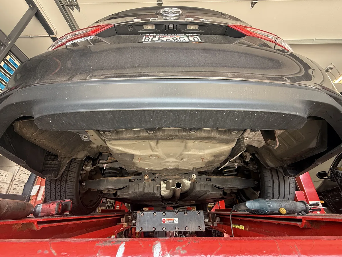 Old rear muffler and tailpipe before replacement