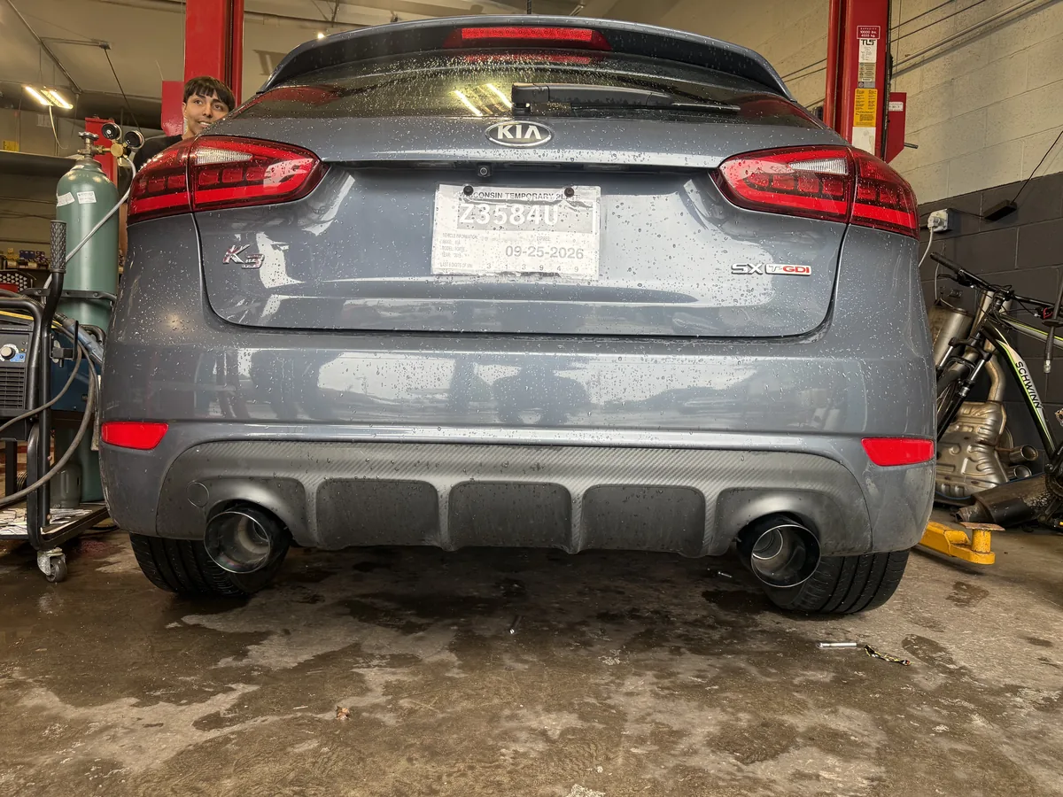 Sedan parked in a service bay at an auto repair shop in Milwaukee